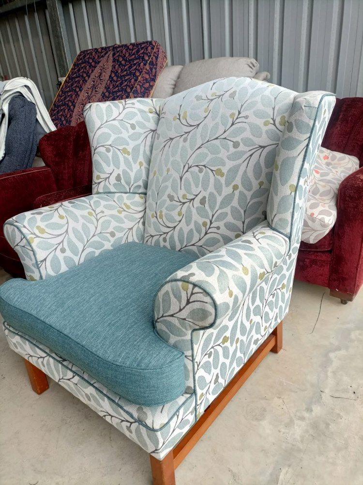 A White And Blue Couch With Pillows On It Is Sitting On A Concrete Floor — Ocean Charm Upholstery In Southport, QLD