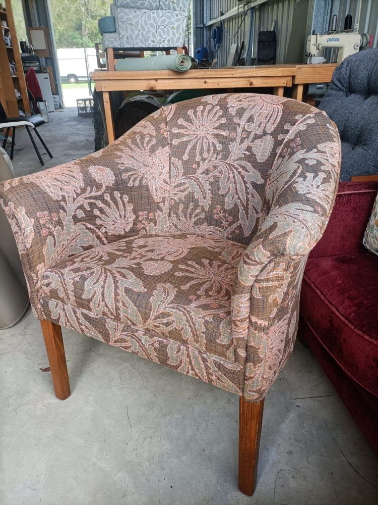 A Chair With A Floral Pattern Is Sitting In A Room  — Ocean Charm Upholstery In Southport, QLD