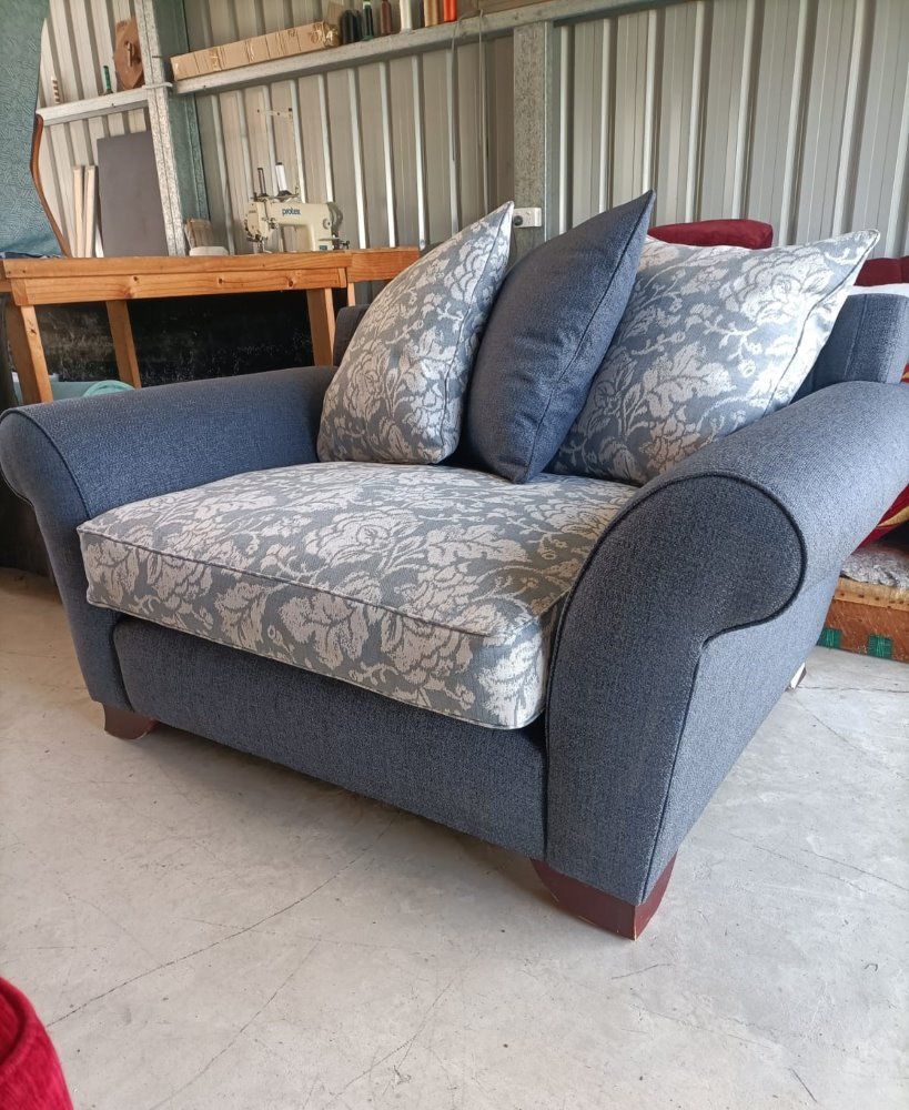A Blue And White Couch With Pillows On It Is Sitting On A Concrete Floor — Ocean Charm Upholstery In Southport, QLD