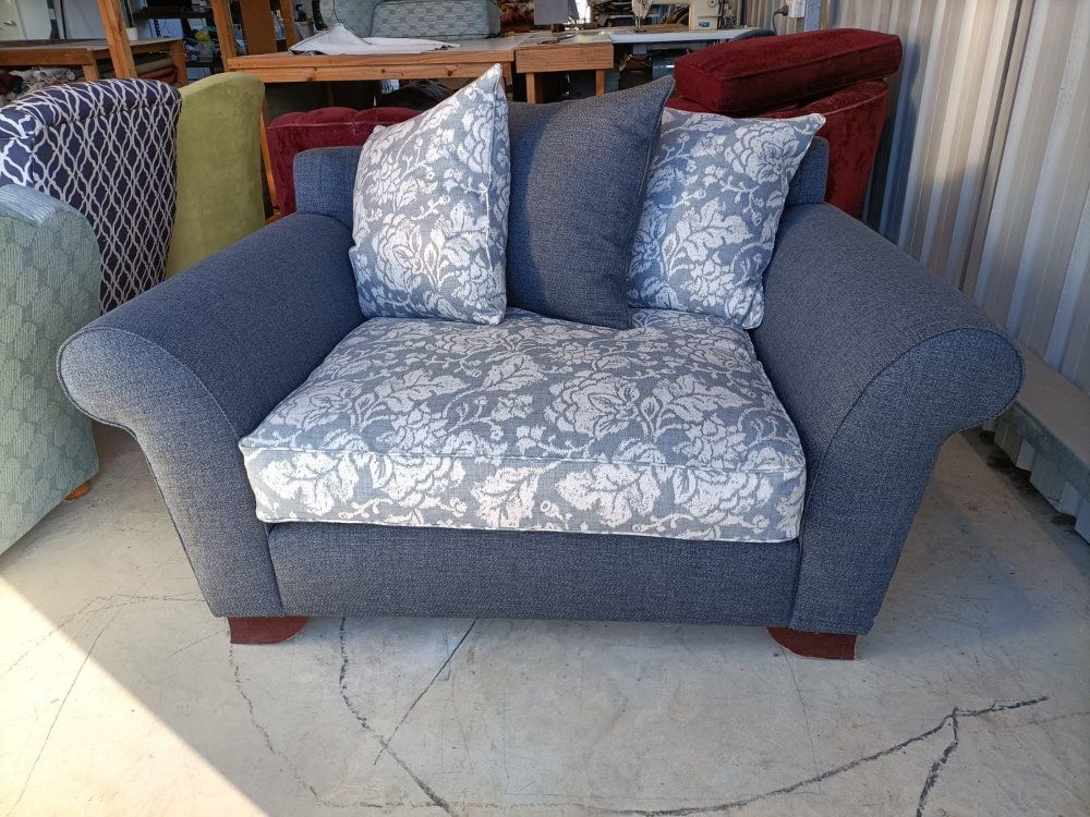A Grey Chair With Two Pillows On It Is Sitting On A Tiled Floor — Ocean Charm Upholstery In Southport, QLD