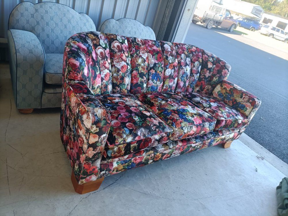 A Colorful Couch With A Floral Pattern Is Sitting In A Garage Next To A Chair  — Ocean Charm Upholstery In Southport, QLD