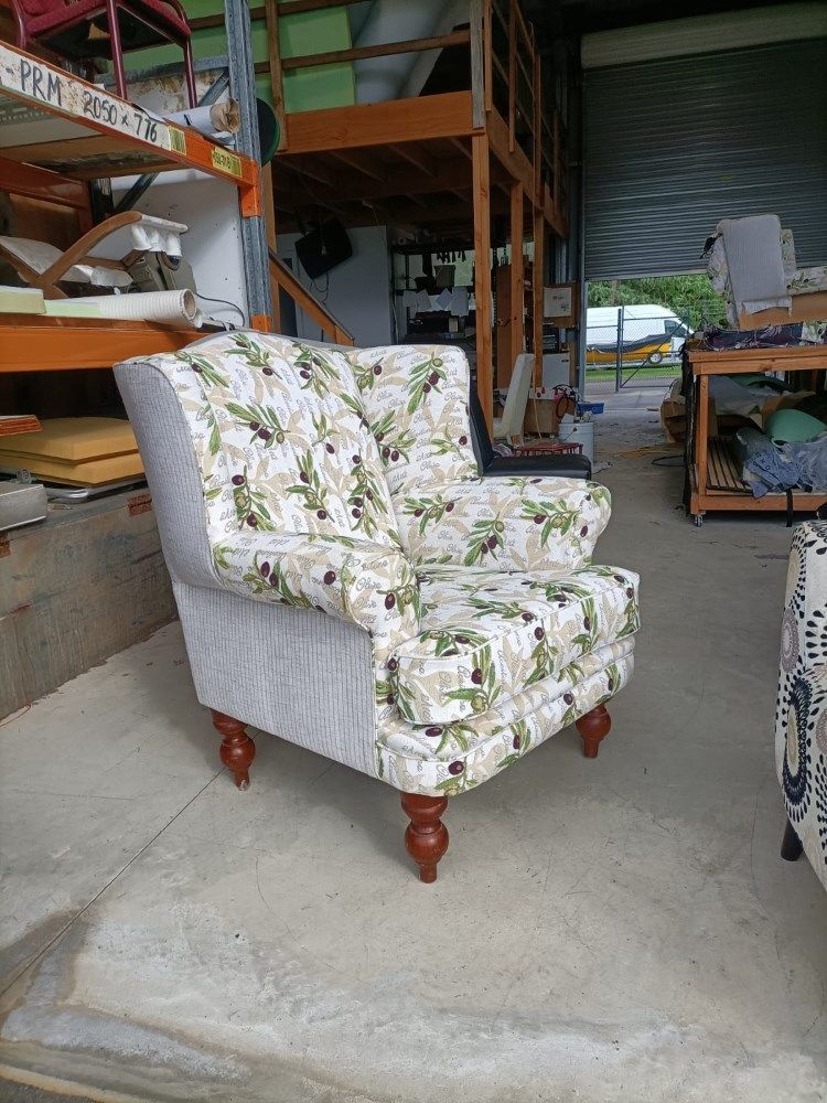 A Chair With A Floral Pattern Is Sitting In A Warehouse  — Ocean Charm Upholstery In Southport, QLD