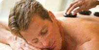 Man Having Stone Massage — Appleton, WI — Advanced Therapeutic Touch & Kay’s 3D Brows