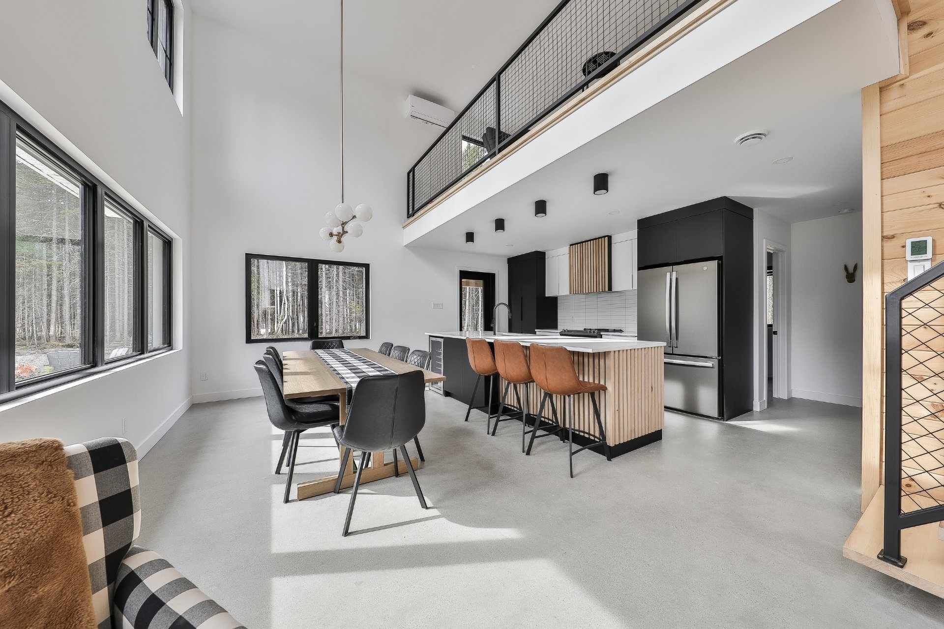 Un grand salon avec une table à manger et des chaises et une cuisine.