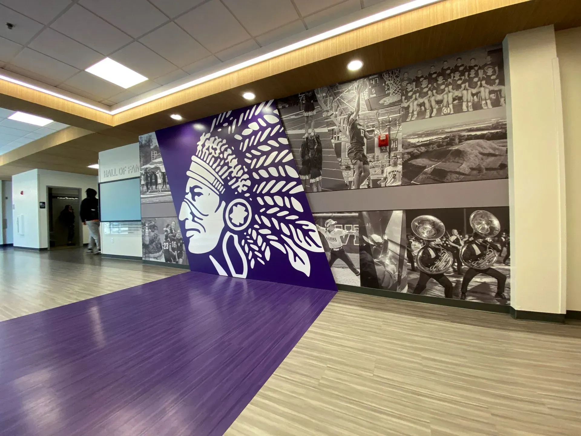 A purple wall with a picture of a native american on it.