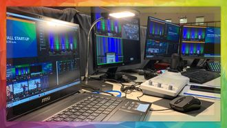 A video production control station with multiple monitors displaying video and editing software.