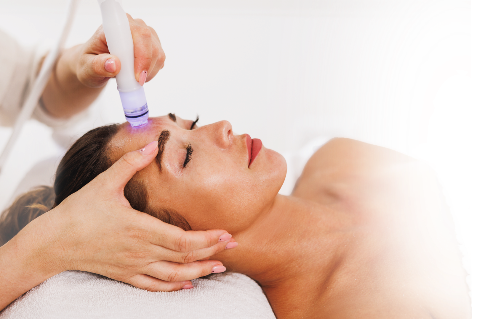 A woman is getting a facial treatment at a spa.