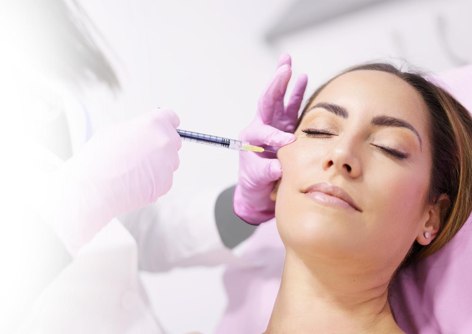 A woman is getting a botox injection in her face.