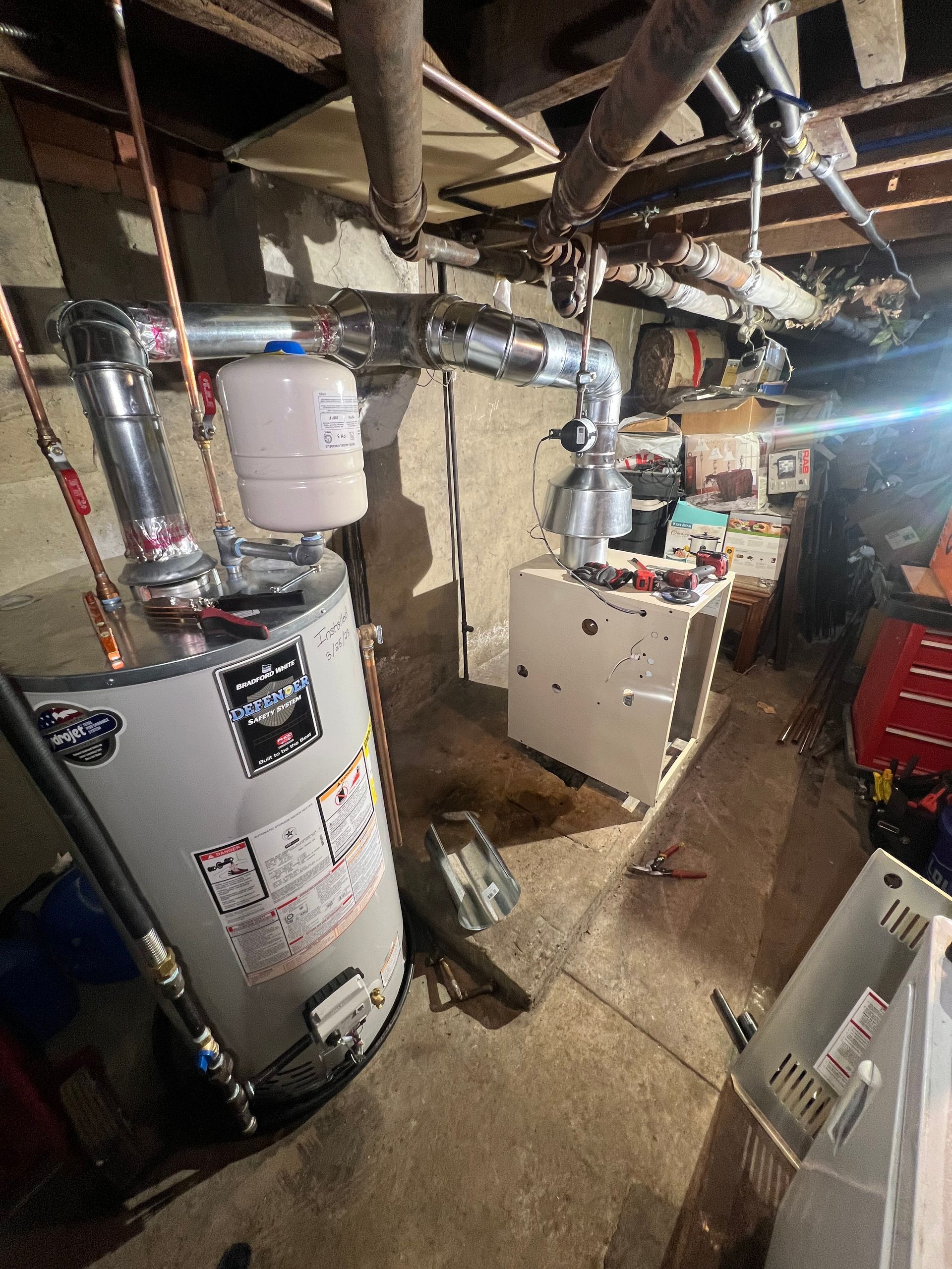 A man and a woman are working on a dishwasher in a kitchen.