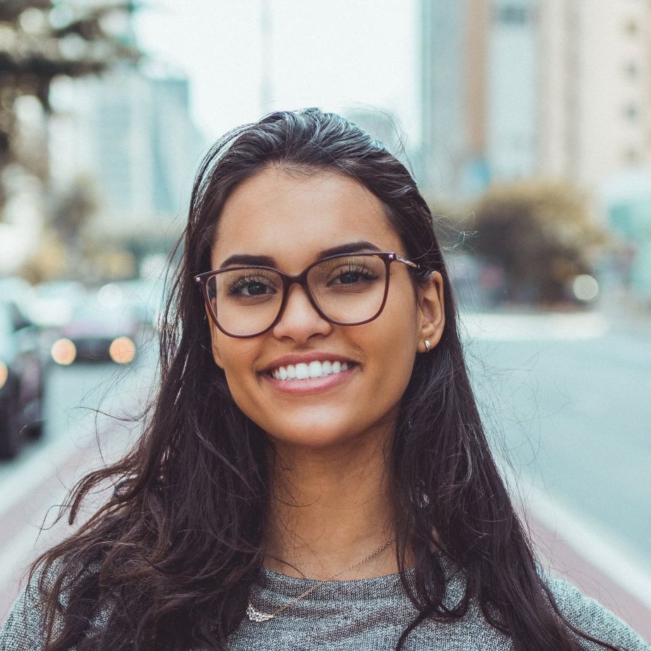 The woman is wearing glasses and smiling for the camera.