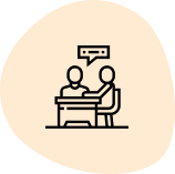 Two people at a table, one talking, with speech bubble.