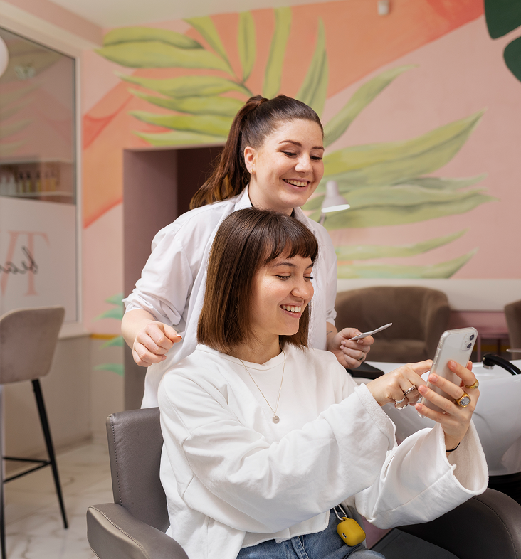 Woman getting her hair washed in a salon, receiving head massage with soapy shampoo.