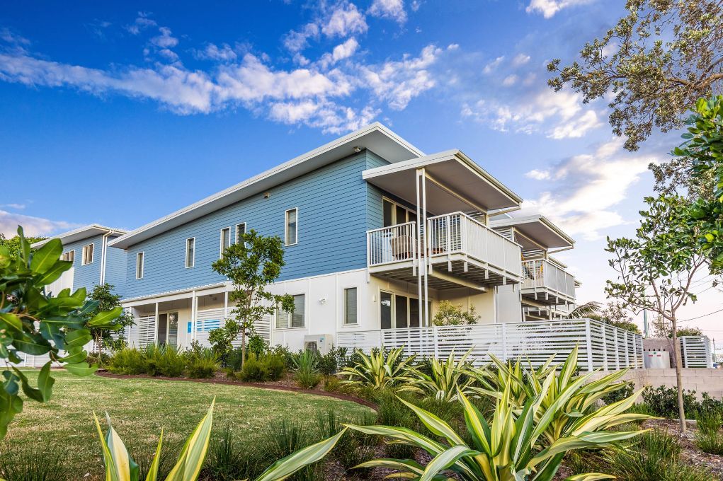 Blue And White Modern Houses With Garden — Electricians in Coffs Harbour, NSW