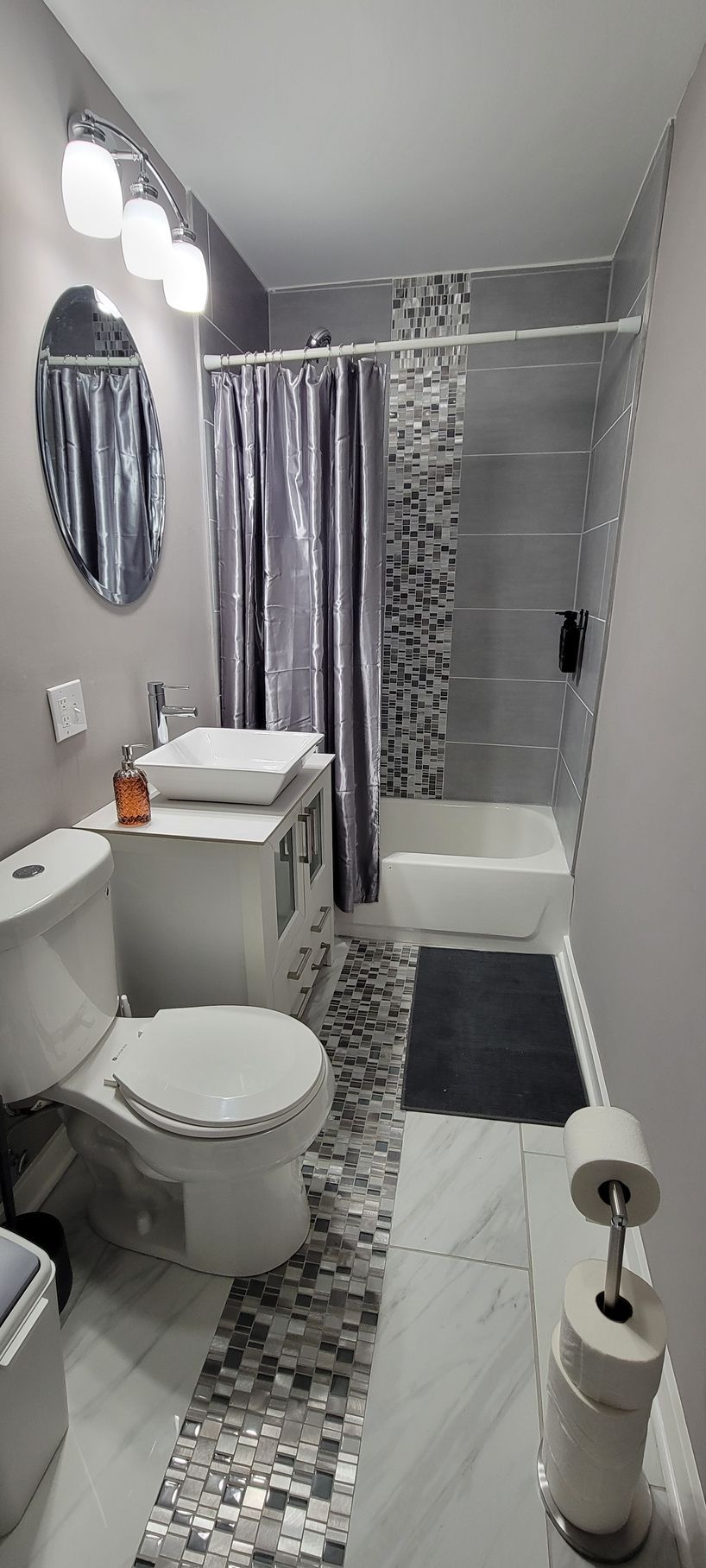 A bathroom with a toilet , sink , and shower.