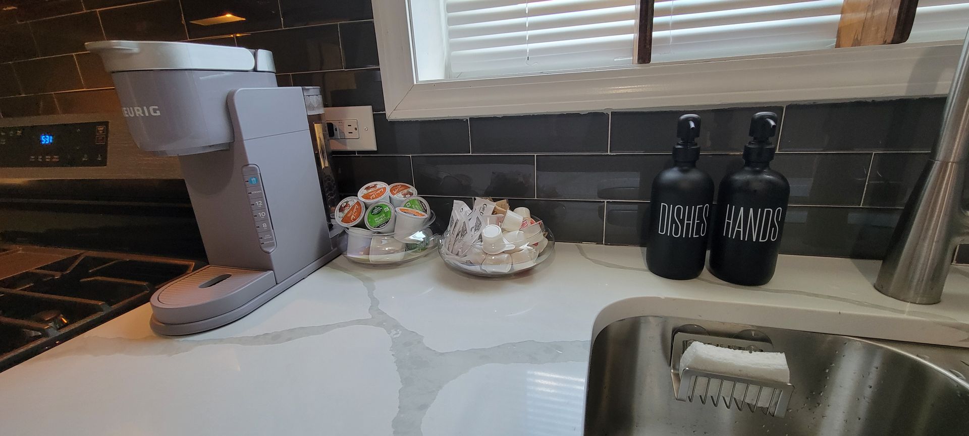 A kitchen counter with a sink and a coffee maker.