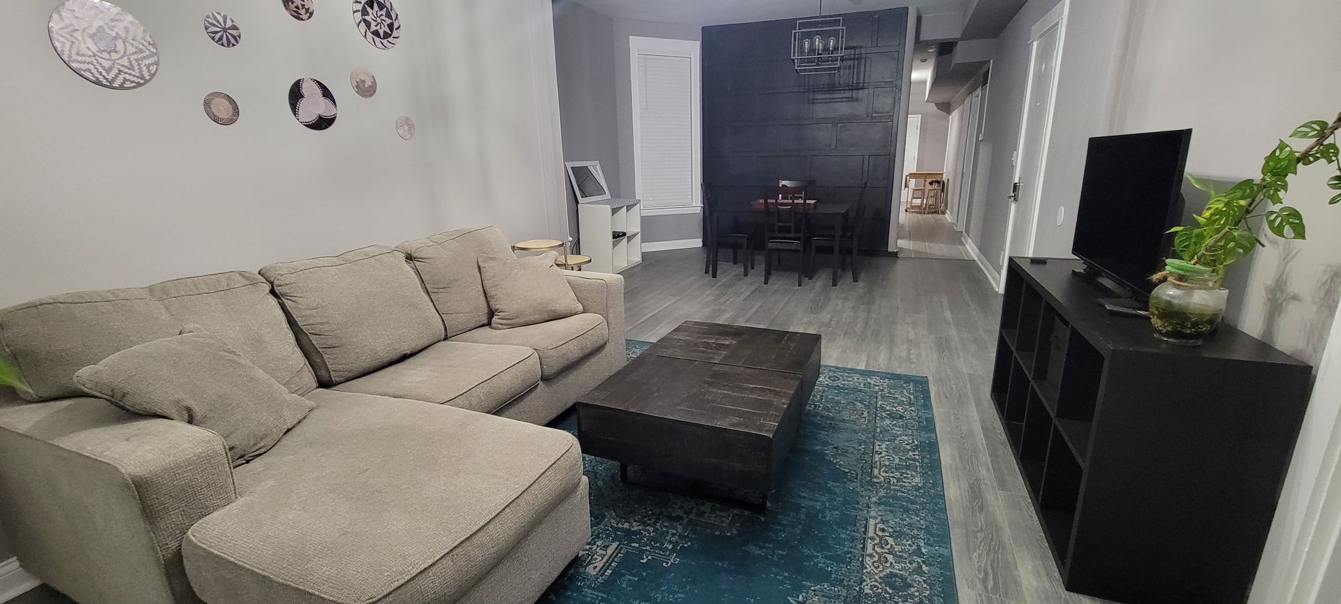 A living room with a couch , coffee table , and television.