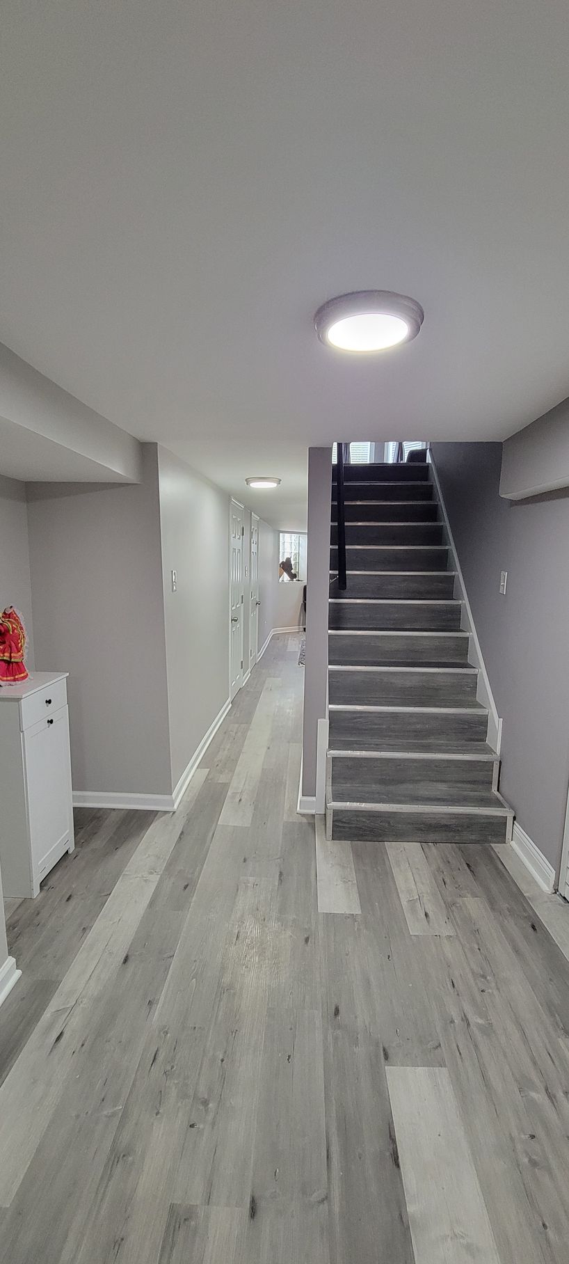 A hallway with stairs leading up to the second floor of a house.