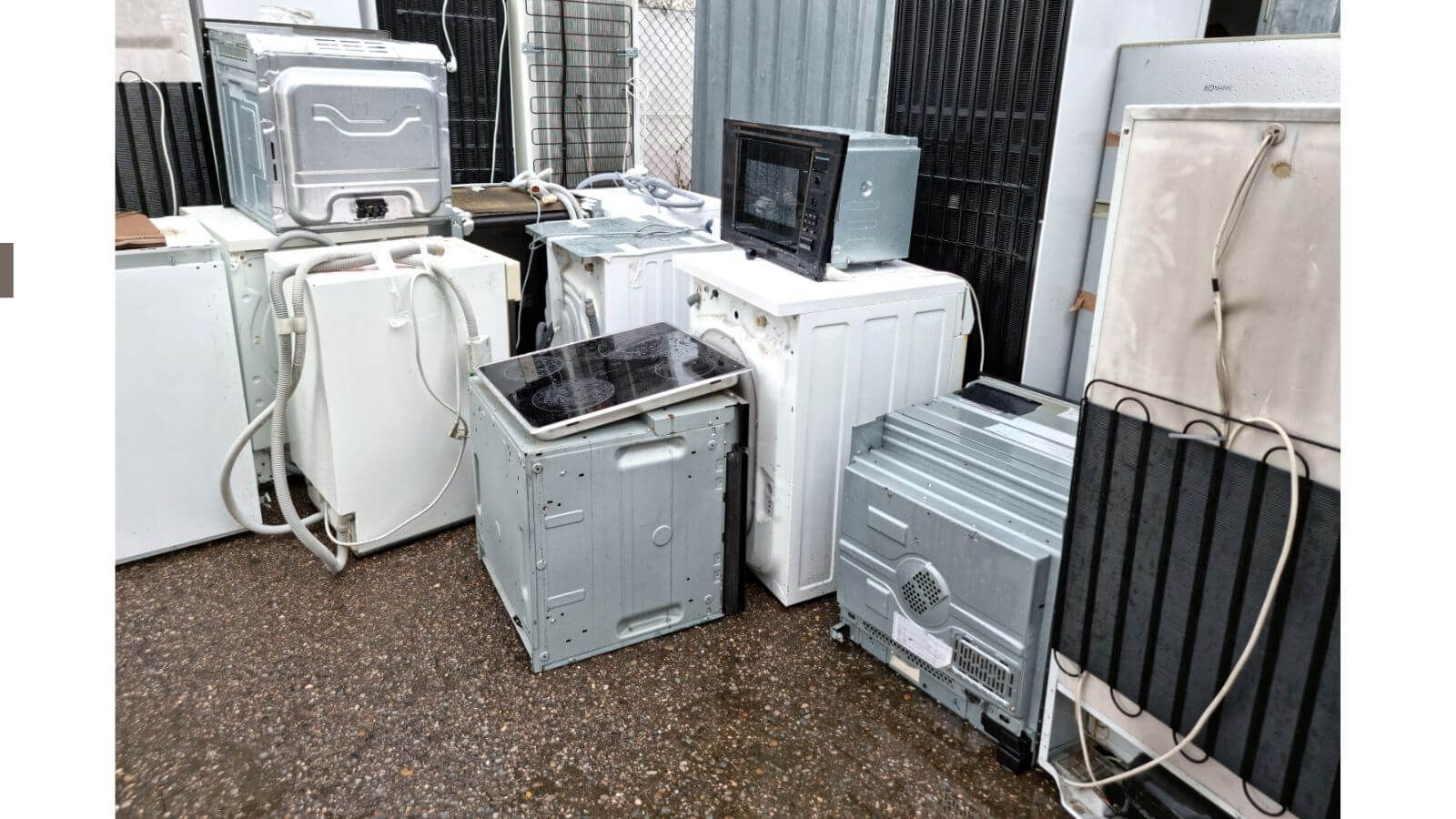 Old appliances including washers, dryers, and microwaves ready for junk removal.