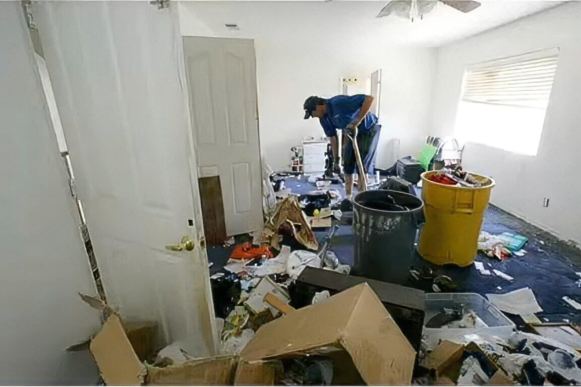 Home cleanout with junk removal contractor clearing clutter from a home interior.