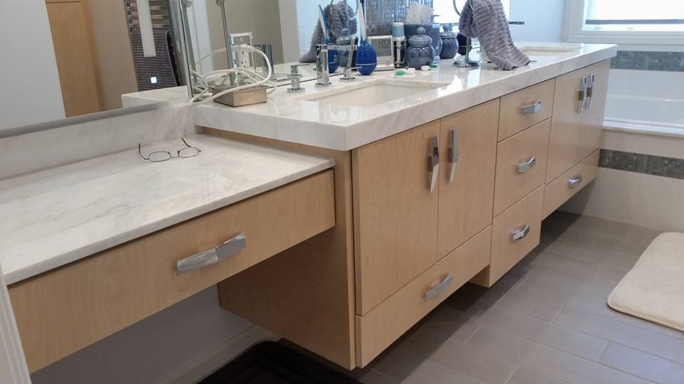 A bathroom with two sinks , a mirror and a bathtub.