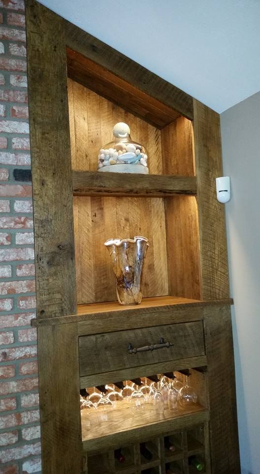 A wooden shelf with a wine rack and glasses on it.