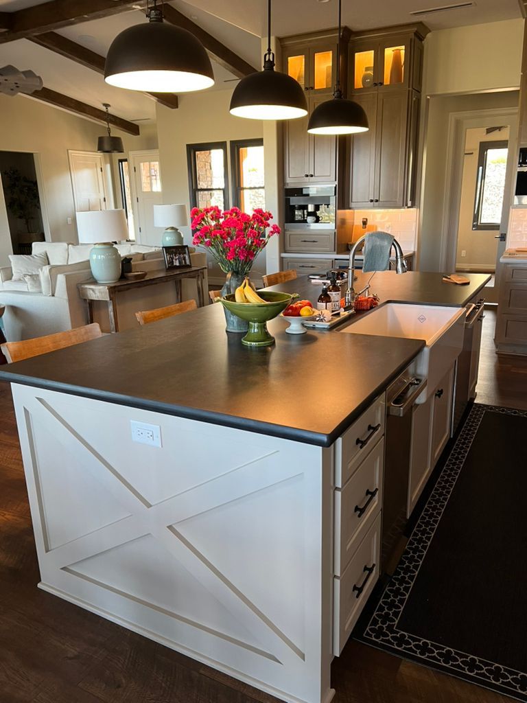 A kitchen with a large island and a sink