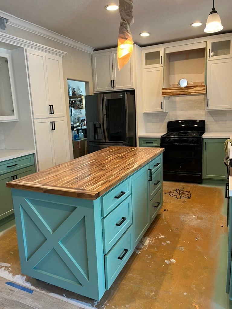 A kitchen with a large island in the middle of it.