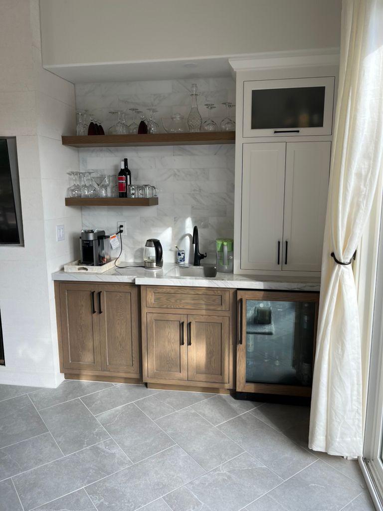 A kitchen with wooden cabinets and a refrigerator