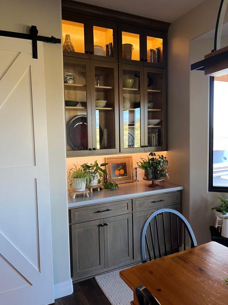 A dining room with a table and chairs and a sliding barn door.