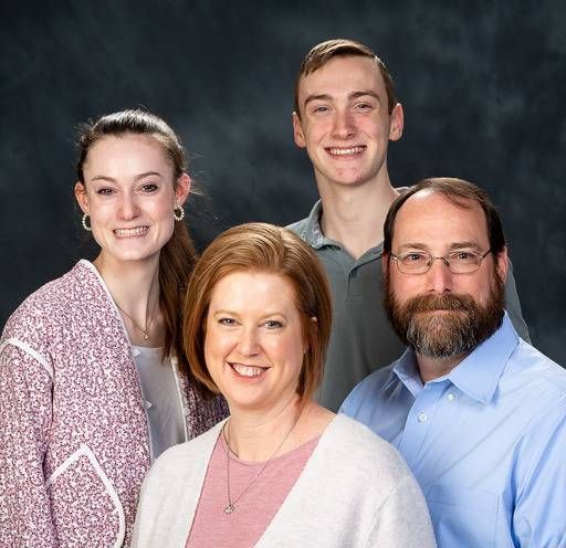 A group of people are posing for a picture and smiling for the camera