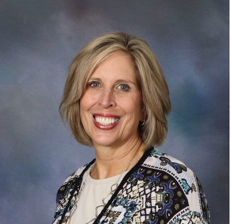 A woman is smiling for the camera.