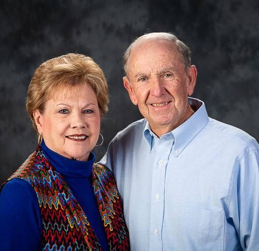 A man and a woman are posing for a picture together.