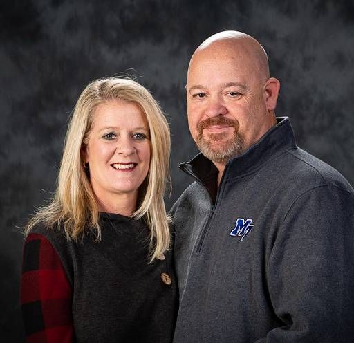 A man and a woman are posing for a picture together.