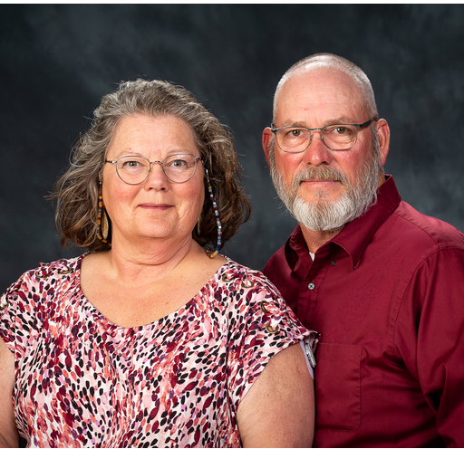 A man and a woman are posing for a picture together.