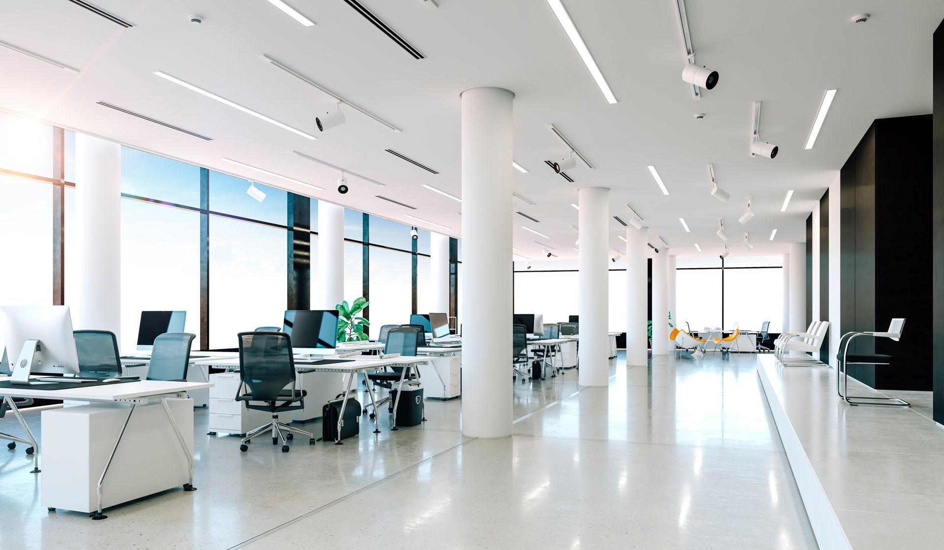 Empty room with light gray walls, hardwood floor, window, stepladder, and painting supplies.