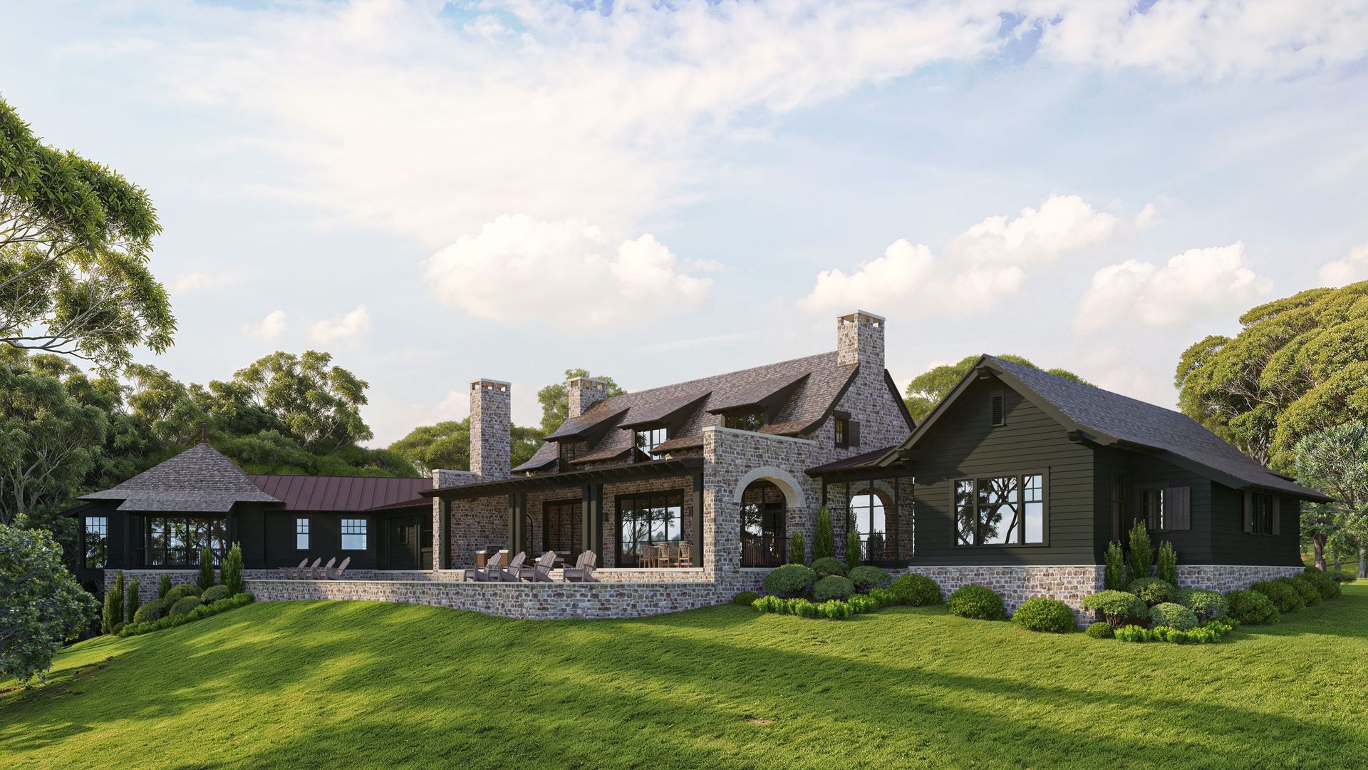 Stone and black wood home on a grassy hill; trees in the background, blue sky.
