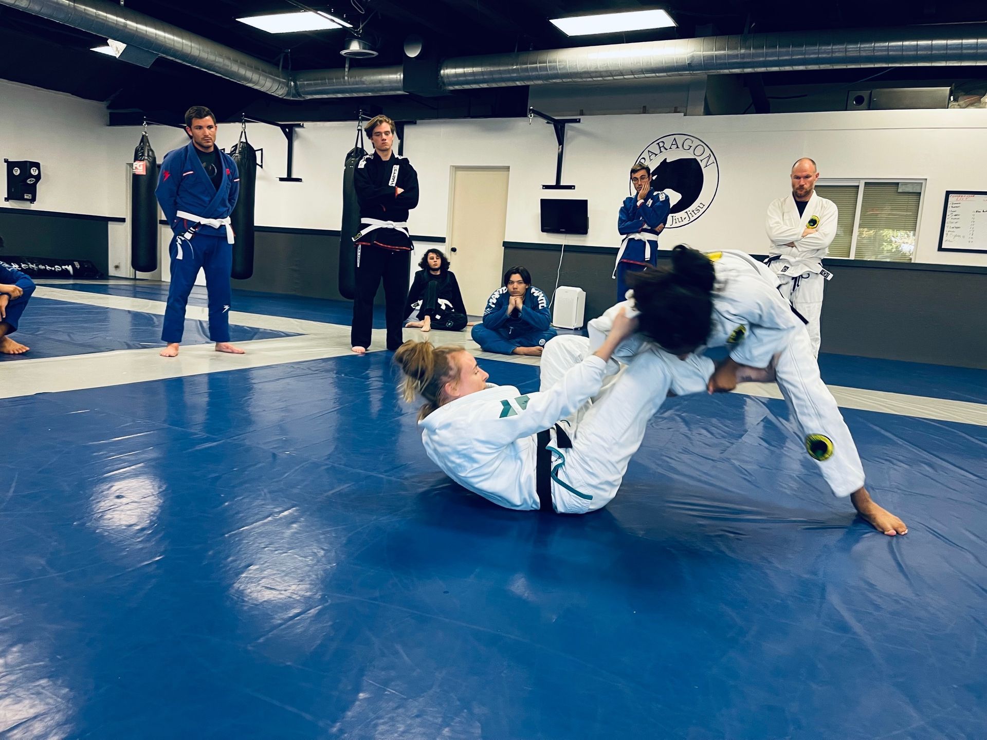 Adults drilling grappling technique at Paragon Simi Valley in Simi Valley, CA, building fitness.