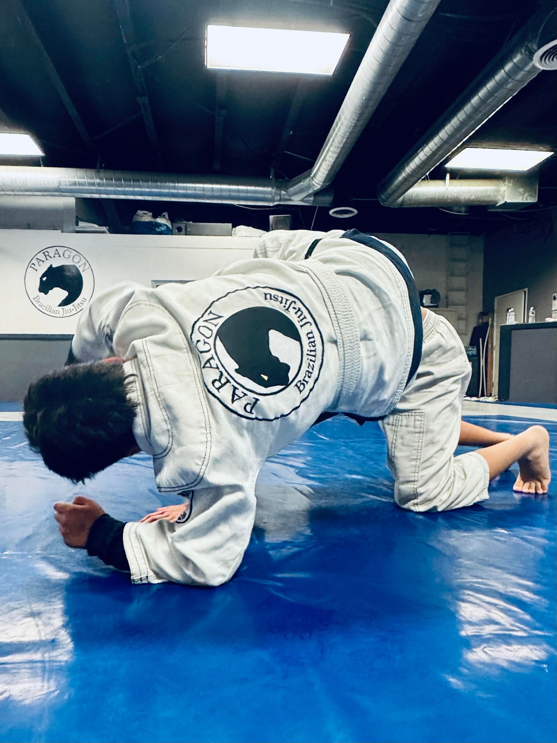 Students drill Brazilian jiu jitsu guard passing at Paragon Simi Valley in Simi Valley, CA.