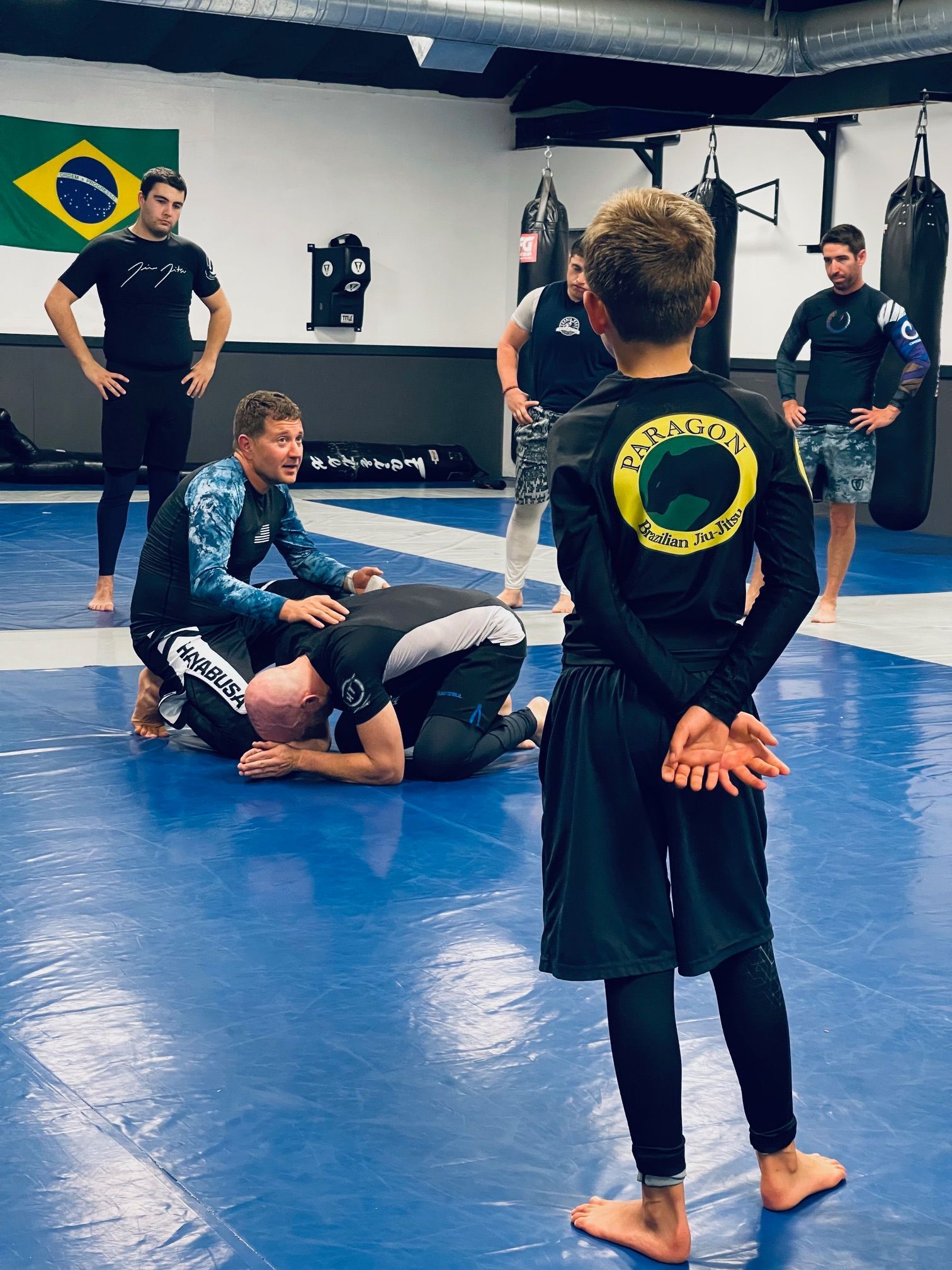 Beginner Brazilian Jiu-Jitsu students practicing techniques at Paragon Simi Valley martial arts gym.