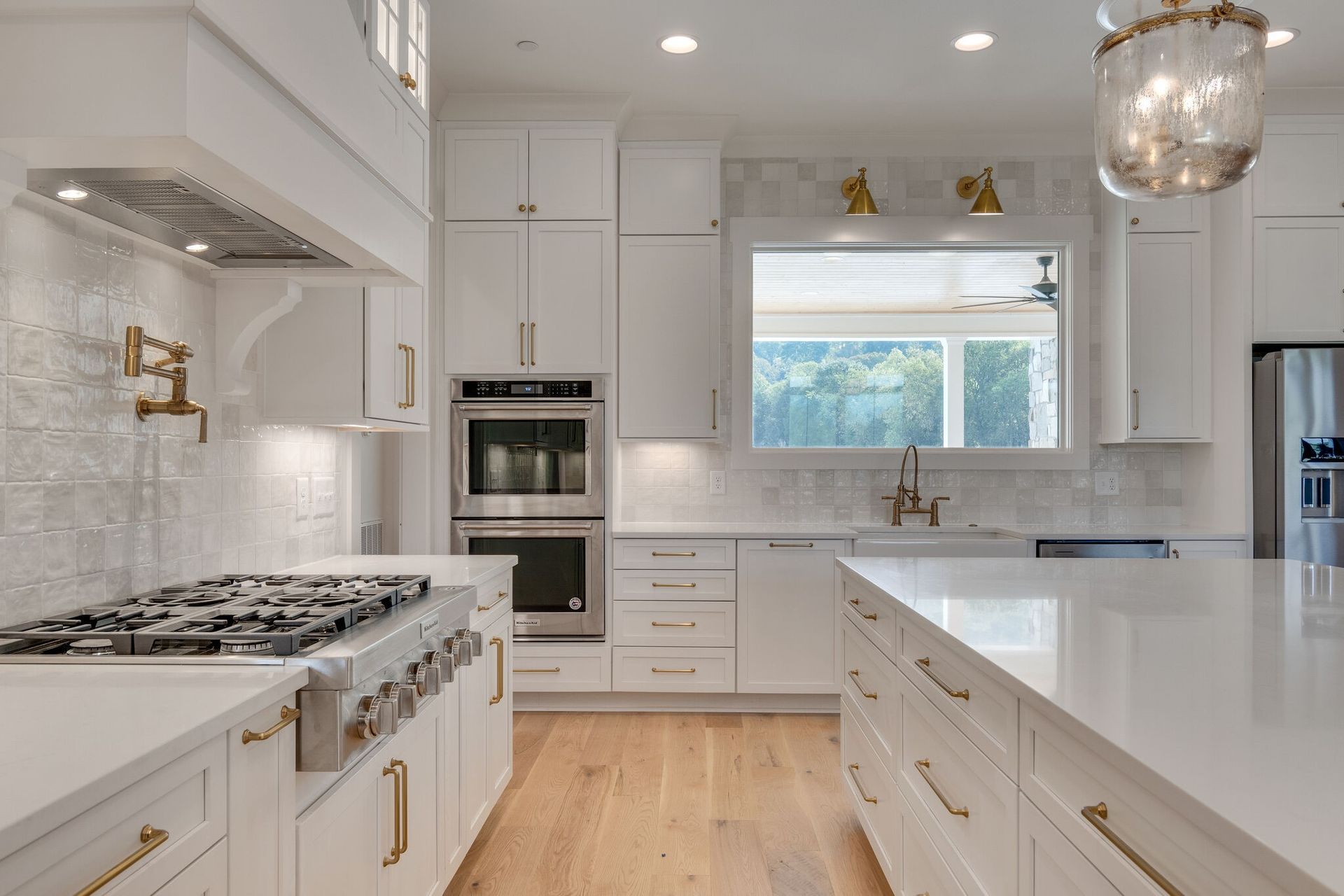 Elegant kitchen with dark wood cabinets, granite countertops, and stainless steel appliances.