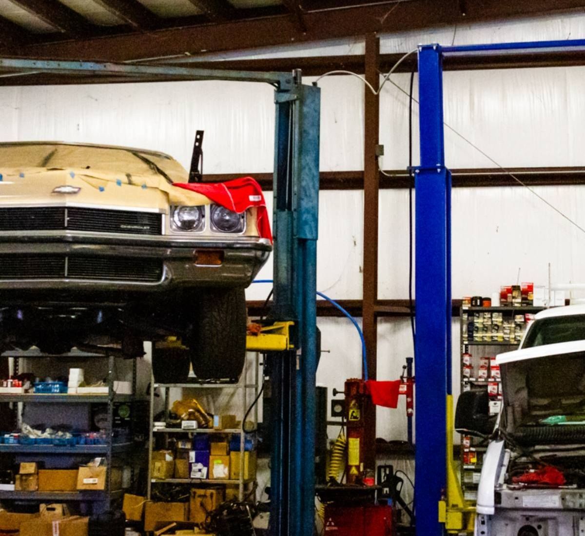 A car is sitting on a lift in a garage