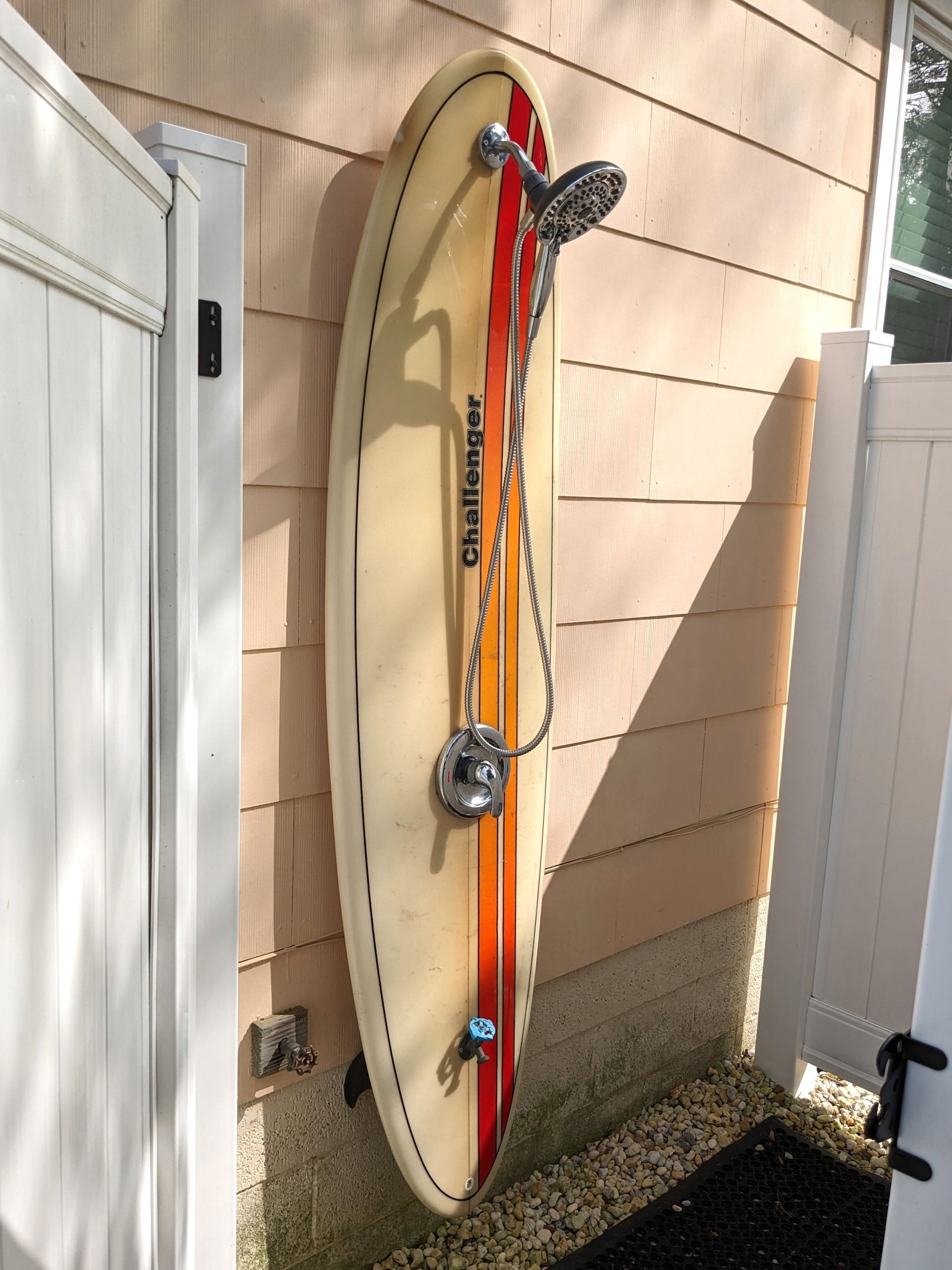 A challenger surfboard with a shower attached to it