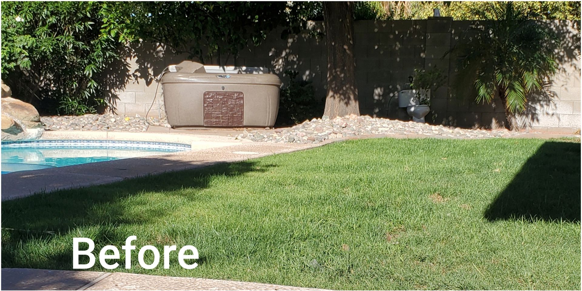 A before picture of a backyard with a hot tub