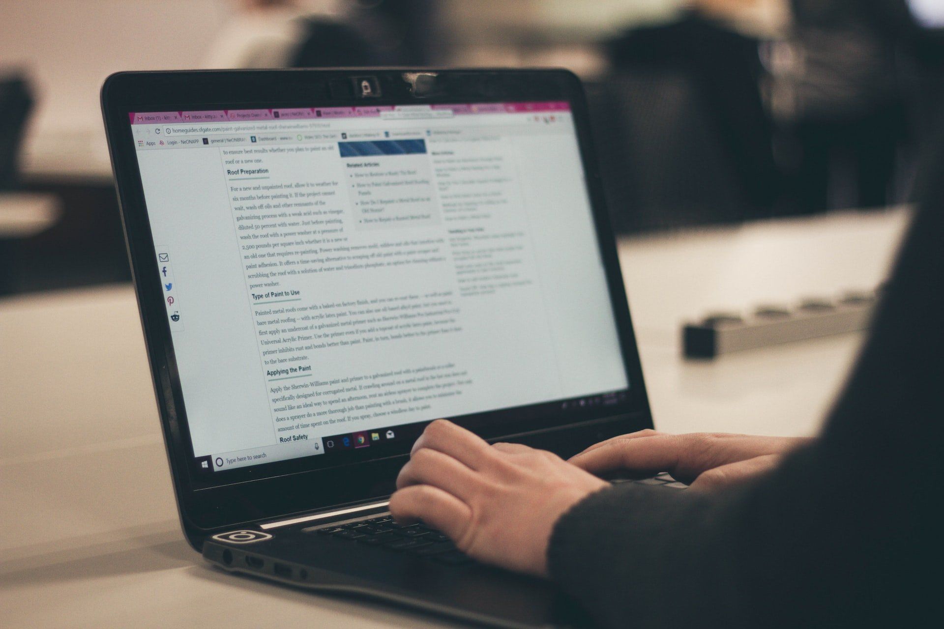 A person is typing on a laptop computer.