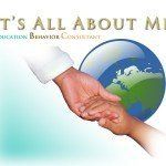 a person is holding another person 's hand in front of a globe .