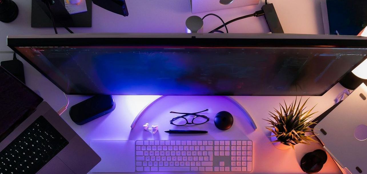 A man is sitting at a desk using a laptop computer.