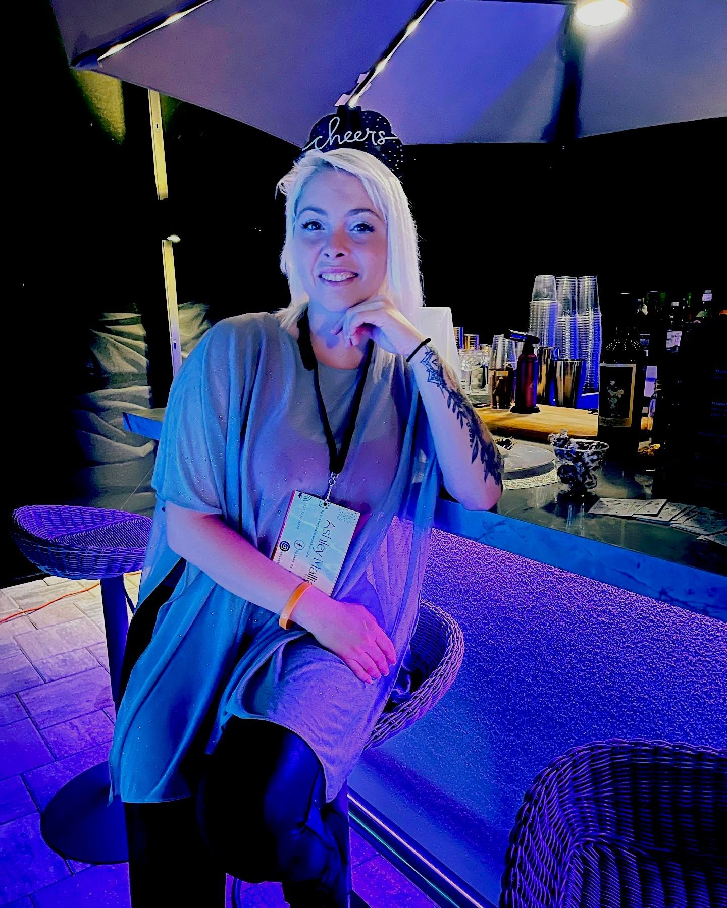 A man is pouring a martini into a martini glass at a party.