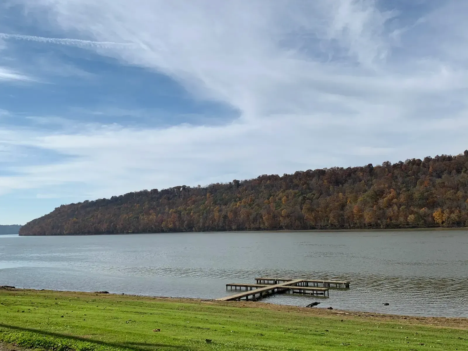 A large body of water with a dock in the middle of it.