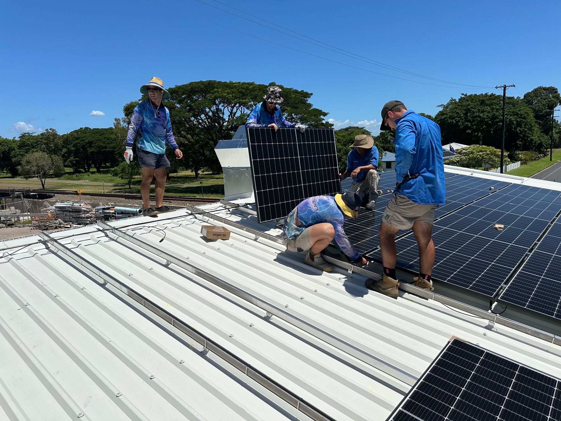 Men Installing Solar Panel — Lahtinen Electrical And Refrigeration in Ingham, QLD