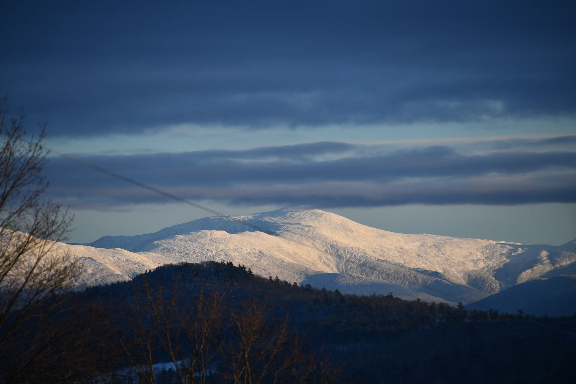 A view of snow-covered mountains from Ostara's Grove Flower Farm in Vermont